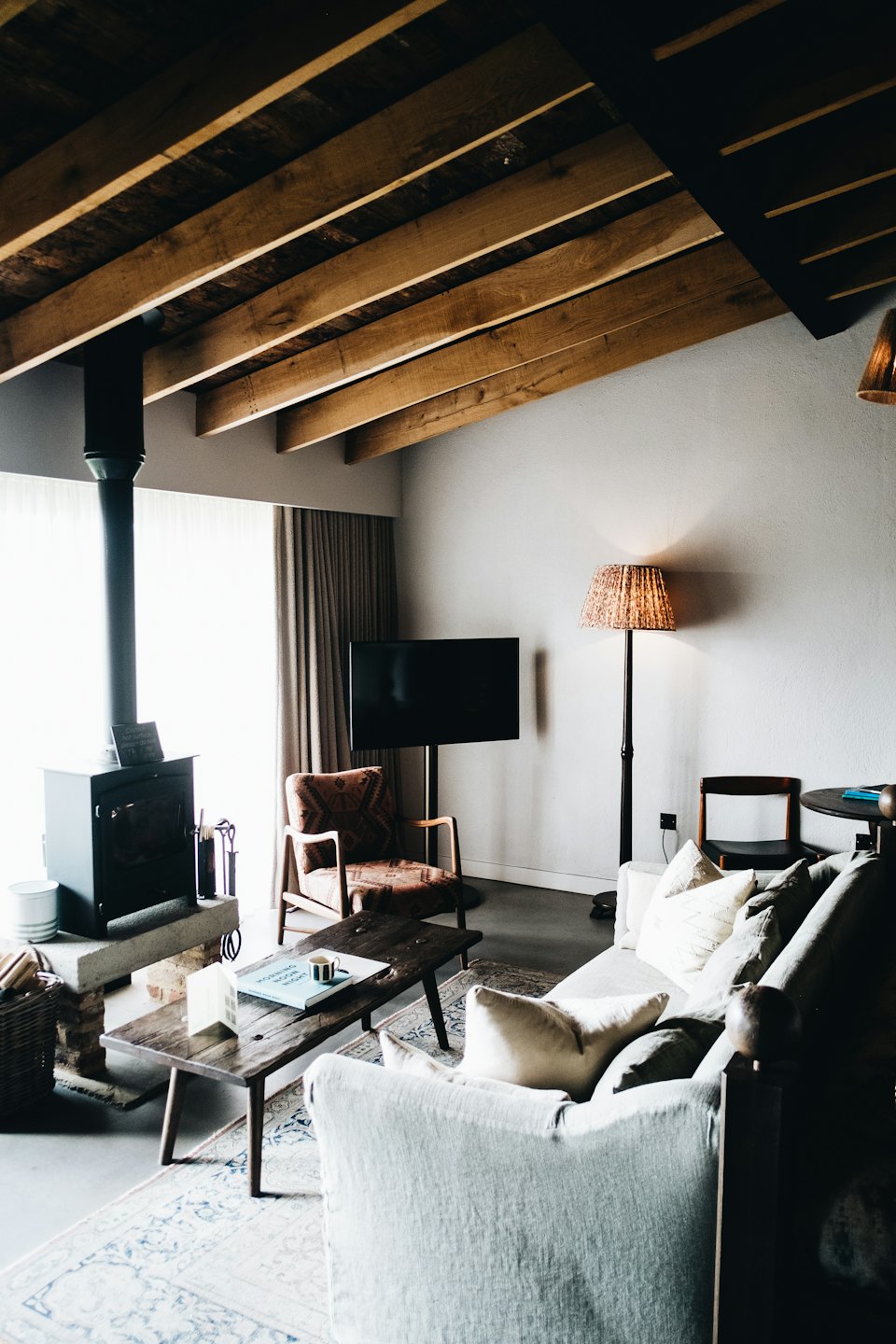 Cozy living room with wood stove and modern furniture.
