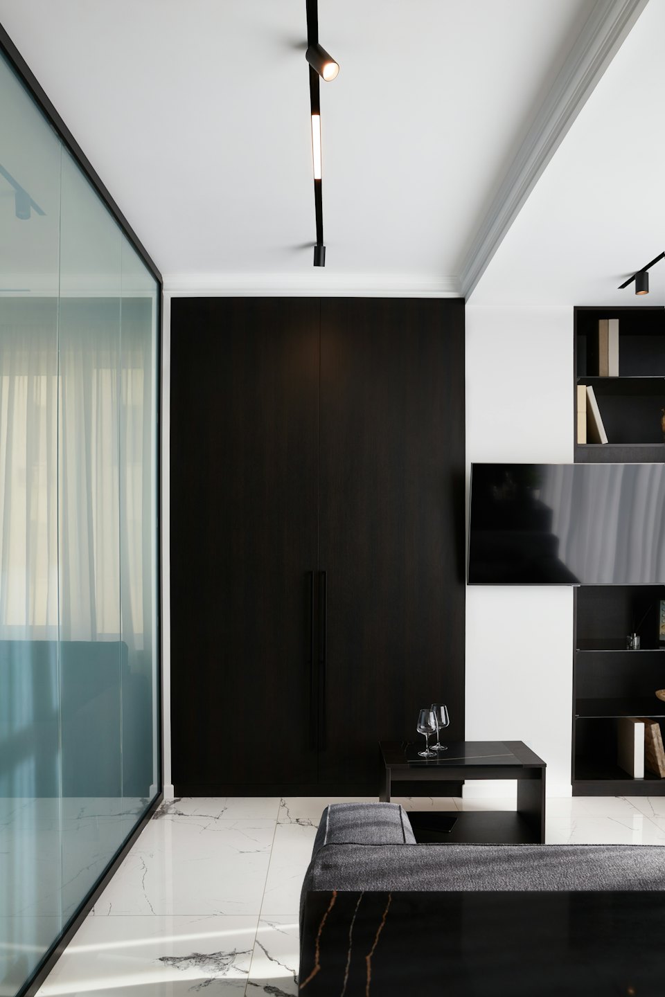 Modern living room with dark wood cabinet and marble floor.