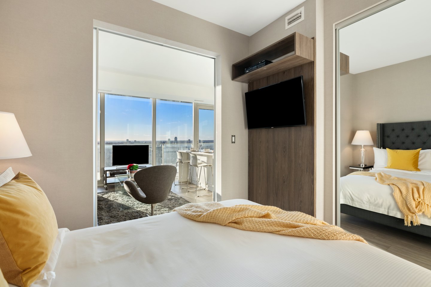 Modern studio apartment with city views through floor to ceiling windows.