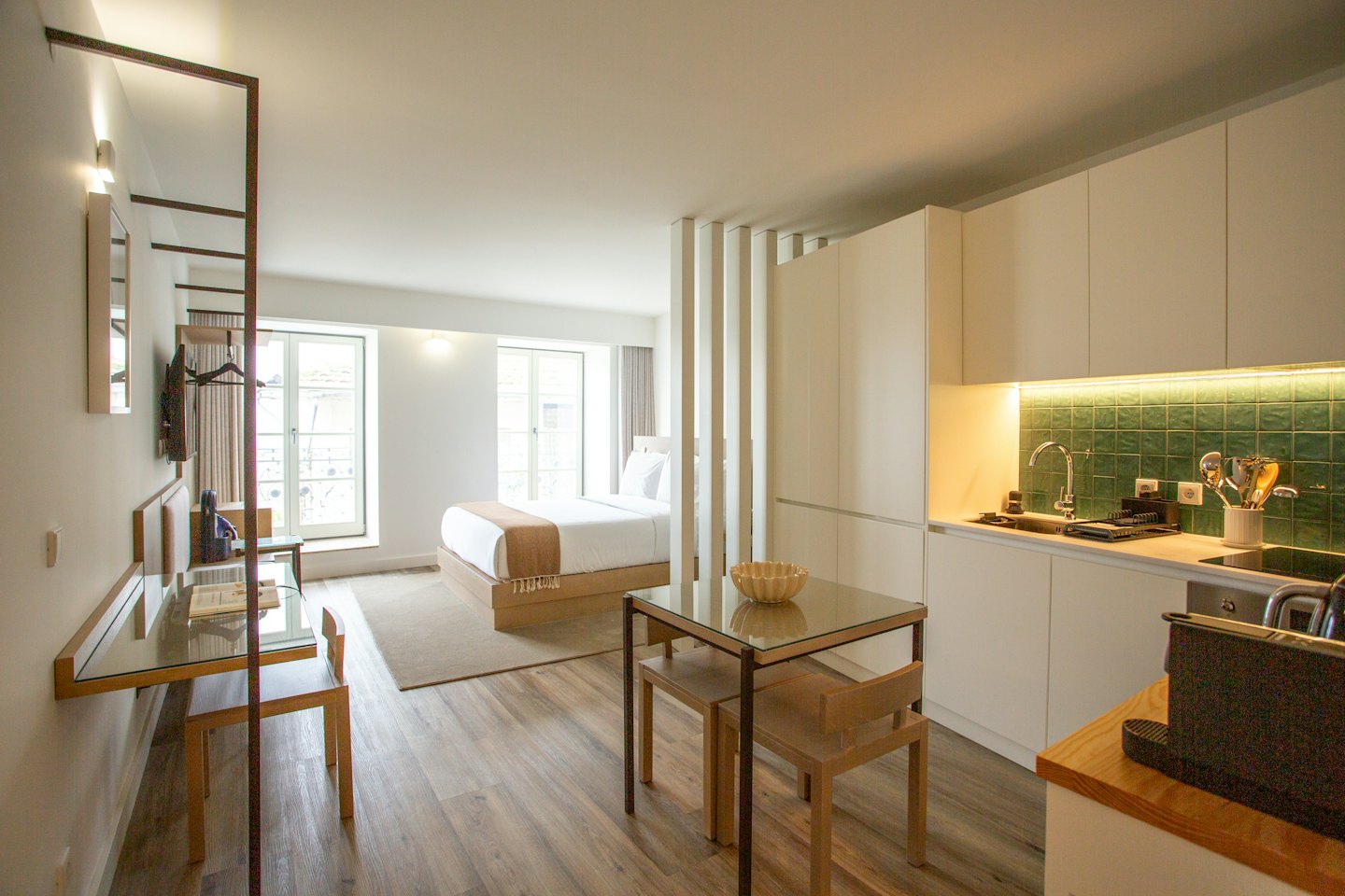 Modern studio apartment with open plan living, dining, and kitchen areas.