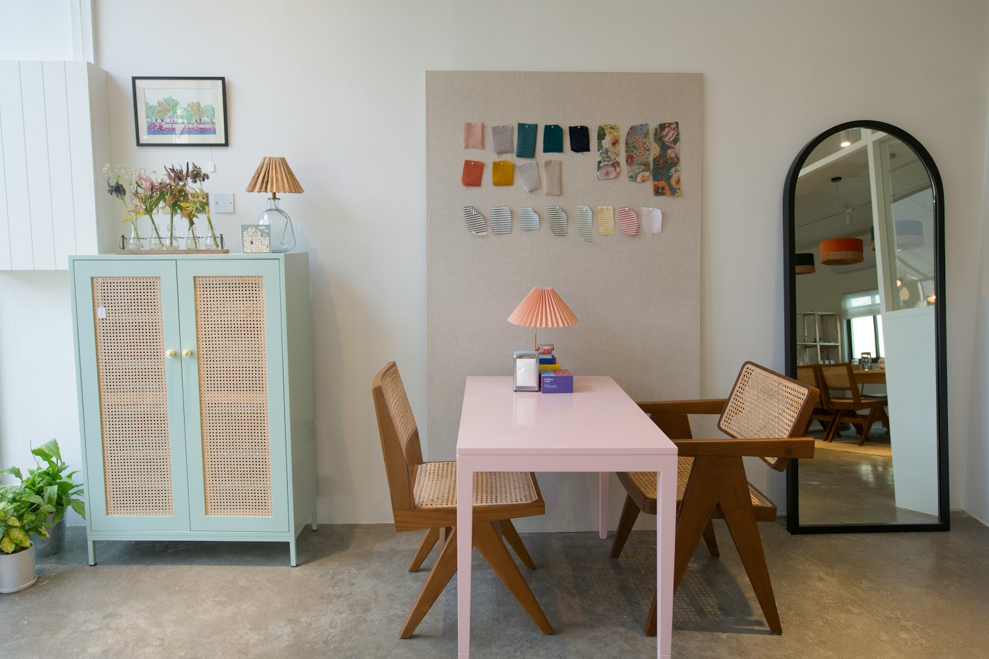 Design studio with a green cabinet and fabric swatches.